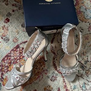 Silver evening shoe with rhinestone accents.